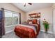 Guest bedroom with orange bedding and southwestern art at 10724 S Mustang Dr, Goodyear, AZ 85338