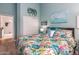 Bedroom with tropical bedding and light teal walls at 10724 S Mustang Dr, Goodyear, AZ 85338