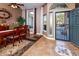 Bright dining room features a wood table with six chairs and tile flooring at 10724 S Mustang Dr, Goodyear, AZ 85338