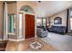 Bright and spacious entryway with tile floors and a view to the living room at 10724 S Mustang Dr, Goodyear, AZ 85338