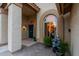 Front entrance with arched window and decorative fountain at 10724 S Mustang Dr, Goodyear, AZ 85338