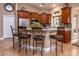 Kitchen with granite counters, wood cabinets, and bar seating at 10724 S Mustang Dr, Goodyear, AZ 85338