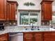 Modern kitchen sink with granite countertops and dark wood cabinets at 10724 S Mustang Dr, Goodyear, AZ 85338