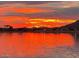 Stunning sunset view reflecting on the lake's still waters at 10724 S Mustang Dr, Goodyear, AZ 85338