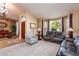 Spacious living room with leather sofas and large windows at 10724 S Mustang Dr, Goodyear, AZ 85338