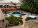 Relaxing backyard with a sparkling pool, hot tub, and landscaping at 10724 S Mustang Dr, Goodyear, AZ 85338