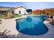 Inviting kidney-shaped pool with waterfall feature at 10724 S Mustang Dr, Goodyear, AZ 85338