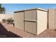 Tan metal storage shed in backyard at 10724 S Mustang Dr, Goodyear, AZ 85338