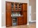 Built-in wet bar with granite countertop, wine cooler, and ample storage at 10724 S Mustang Dr, Goodyear, AZ 85338