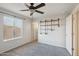 Bedroom with ceiling fan, built-in shelving, and gray carpet at 1132 W Santa Gertrudis Trl, San Tan Valley, AZ 85143