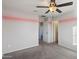 Bedroom with pink stripes, ceiling fan, and access to bathroom at 1132 W Santa Gertrudis Trl, San Tan Valley, AZ 85143