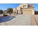 Two-story house with a large driveway and landscaping at 1132 W Santa Gertrudis Trl, San Tan Valley, AZ 85143