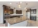 Spacious kitchen with dark wood cabinets and granite countertops at 1132 W Santa Gertrudis Trl, San Tan Valley, AZ 85143