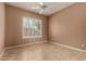 Simple bedroom with ceiling fan and window shutters at 11664 E Caron St, Scottsdale, AZ 85259