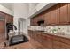 Spacious kitchen with granite countertops and dark wood cabinets at 11664 E Caron St, Scottsdale, AZ 85259