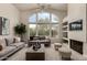 Living room with a fireplace, large windows, and ample natural light at 11664 E Caron St, Scottsdale, AZ 85259