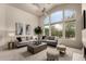 Living area with gray sofas, a coffee table, and a large window at 11664 E Caron St, Scottsdale, AZ 85259