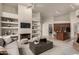 Open concept living room with kitchen views and built-in shelving at 11664 E Caron St, Scottsdale, AZ 85259