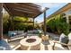 Covered patio with fire pit and seating area, perfect for outdoor entertaining at 11664 E Caron St, Scottsdale, AZ 85259