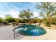 Freeform pool with waterfall feature and spacious deck at 11664 E Caron St, Scottsdale, AZ 85259