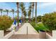 Pathway to pool; lush landscaping, palm trees, lounge chairs, and umbrellas at 11664 E Caron St, Scottsdale, AZ 85259