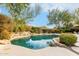 Inviting kidney shaped pool surrounded by desert landscaping at 11664 E Caron St, Scottsdale, AZ 85259