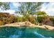 Relaxing pool area with waterfall and desert landscaping at 11664 E Caron St, Scottsdale, AZ 85259