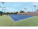 Well-maintained tennis court with green surrounds at 11664 E Caron St, Scottsdale, AZ 85259