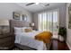 Bright bedroom with plush bedding and access to balcony at 11683 N 135Th Pl, Scottsdale, AZ 85259