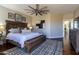 Main bedroom with a king-size bed and a ceiling fan at 11683 N 135Th Pl, Scottsdale, AZ 85259