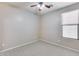 Well-lit bedroom with large window and ceiling fan at 11820 W Monte Lindo Ln, Sun City, AZ 85373