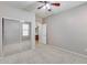 Bright bedroom featuring mirrored closet doors and ceiling fan at 11820 W Monte Lindo Ln, Sun City, AZ 85373