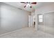 Bright bedroom with ceiling fan, mirrored closet doors, and carpet flooring at 11820 W Monte Lindo Ln, Sun City, AZ 85373