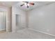 Spacious bedroom featuring a ceiling fan and mirrored closet doors at 11820 W Monte Lindo Ln, Sun City, AZ 85373