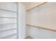 Walk-in closet with shelves and hanging rods at 11820 W Monte Lindo Ln, Sun City, AZ 85373