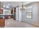 Spacious dining area with a chandelier and window providing natural light at 11820 W Monte Lindo Ln, Sun City, AZ 85373