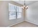 Bright dining area with large window and stylish chandelier at 11820 W Monte Lindo Ln, Sun City, AZ 85373