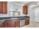 Modern kitchen with dark wood cabinets and granite countertops at 11820 W Monte Lindo Ln, Sun City, AZ 85373