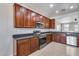 Well-equipped kitchen boasting stainless steel appliances and rich wood cabinets at 11820 W Monte Lindo Ln, Sun City, AZ 85373