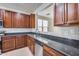 Kitchen with dark wood cabinets and granite countertops at 11820 W Monte Lindo Ln, Sun City, AZ 85373