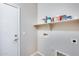 Bright laundry room with shelving and a door at 11820 W Monte Lindo Ln, Sun City, AZ 85373