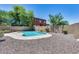 Landscaped backyard with a kidney-shaped pool at 11820 W Monte Lindo Ln, Sun City, AZ 85373