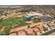 Aerial view showing a school and neighborhood homes with pools at 11860 W Grant St, Avondale, AZ 85323