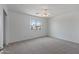 Bright bedroom with carpet flooring and a window at 11860 W Grant St, Avondale, AZ 85323