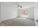 Charming bedroom with ceiling fan and carpet at 11860 W Grant St, Avondale, AZ 85323