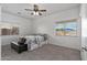 Bedroom with carpeted floor, ceiling fan and view to backyard at 11860 W Grant St, Avondale, AZ 85323