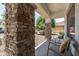 Inviting front porch with stone pillars and comfortable seating at 11860 W Grant St, Avondale, AZ 85323