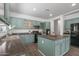 Spacious kitchen island with teal cabinetry and granite countertops at 11860 W Grant St, Avondale, AZ 85323