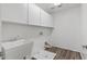 Bright laundry room with built-in cabinets and a utility sink at 11860 W Grant St, Avondale, AZ 85323