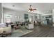 Open concept living room and teal kitchen with an island at 11860 W Grant St, Avondale, AZ 85323